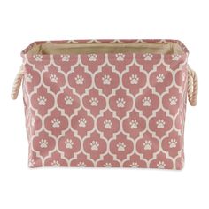 a pink and white dog paw print fabric storage bag with rope handles on an isolated white background