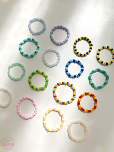 several different colored bracelets sitting on top of a white table next to each other