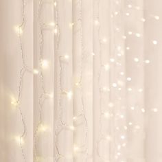 the curtains are covered with white lights