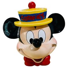 a mickey mouse figurine with a hat on it's head and eyes