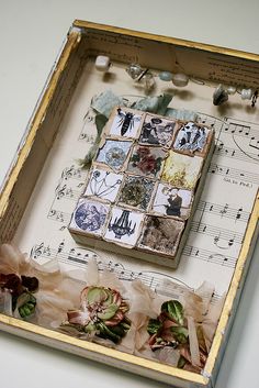 a wooden box filled with lots of different things on top of a white tablecloth