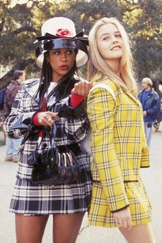 two women standing next to each other wearing hats