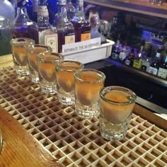 several shot glasses are lined up on a counter