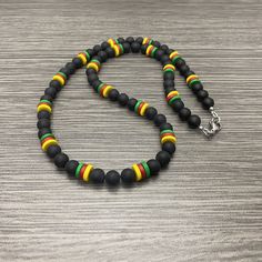 This necklace is made of 7mm round matte black onyx stone beads, 8mm green ceramic rondelle beads, 8mm red ceramic rondelle beads, and  8mm ceramic yellow rondelle beads. It has a stainless steel lobster claw style clasp and stainless steel wire guards. Available in lengths of 20-28 inches. Prices vary. matching bracelet  https://www.etsy.com/listing/1301920489/men-cameroon-flag-inspired-with-brass Black Necklaces With Colorful Oval Beads, Black Necklace With Colorful Oval Beads, Black Jewelry With Colorful Oval Beads, Black Necklace With Oval Spacer Beads, Casual Black Gemstone Beads, Beaded Necklace Men, Cameroon Flag, Red Ceramic, Fredericksburg Va