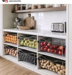 an organized kitchen with lots of food on the shelves and some baskets in front of it