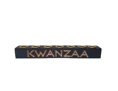 a black and gold sign that says kwanzaa on the side of it