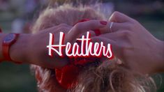 the words heaters are written on top of two women's hands with red bows