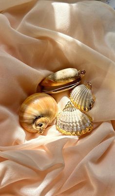 VINTAGE SEASHELL CHARM Quantity: 1 Charm -Select Shell Option In Drop Down Menu ITEM DESCRIPTION This listing is for a vintage seashell charm - while quantities last there are four options to choose from (Moon Shell, olive shell, and a larger or smaller cockle shell). Each shell has luxurious 24kt gold plated detail. I have added a sturdy gold tone metal jump ring to each charm. These would be appropriate to wear on a necklace pendant or as part of a charm necklace. The olive shells and the moon Seashell Charm Necklace, Olive Shell, Libra Necklace, Morristown Nj, Antique Locket, Heart Locket Necklace, Vintage Belt Buckles, Seashell Necklace, Beach Lover