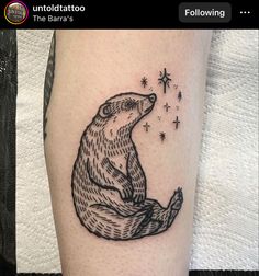 a black and white tattoo of a bear sitting on its hind legs with stars in the background