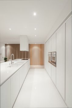 an iphone photo of a kitchen with white cabinets and counter tops, along with the words pin it