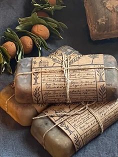 an old book is wrapped in twine and surrounded by oranges on the table