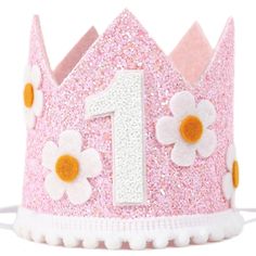 a pink and white princess crown with flowers on the front, number 1 is shown