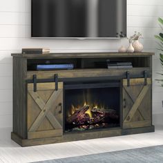 an entertainment center with a fireplace and flat screen tv