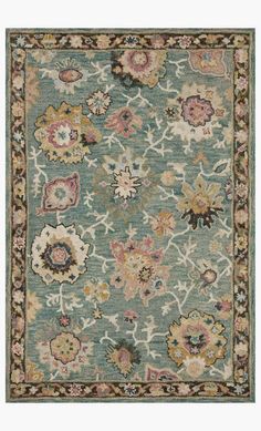 a blue rug with many different flowers on it