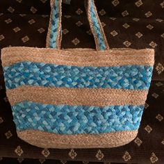 New Chico Blue Beach Tote/Bag Is Woven With Two-Tone Striped Blue Around The Bag And Silver Thread Compliments The Blue Material Throughout. The Inside Of The Spacious Bag Shows It Will Hold Many Items While Shopping Or Lounging At The Pool/Beach. The Bag Also Has A "Snap Closure"! Both Bag's Handle Straps Are 12 Inches Long And The Bottom Of Bag Measures 16in X 8 In. This Larger Tote Is 24 Inches Tall With Handles. One Of The Nicest Beach Bag/Tote That I've Purchased! Blue Tote Bag For Beach, Blue Tote Beach Bag For Beach Season, Blue Rectangular Beachy Bag, Blue Beach Bag With Braided Handles, Blue Straw Bucket Bag With Braided Handles, Blue Bucket Bag For The Beach, Blue Bucket Bag For Beach, Blue Beachy Bags For Beach Season, Blue Bucket Straw Bag For Shopping