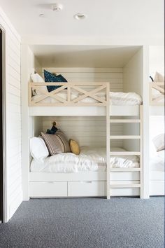 bunk beds in a room with white walls and carpet