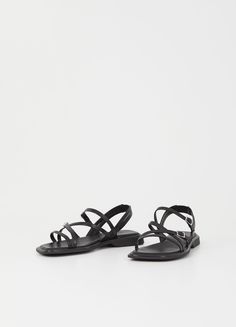 Elevate your everyday look with Izzy, the strappy sandals that exude minimalistic elegance. Crafted from luxurious black leather, these sandals feature a slanted toe shape and double adjustable straps with buckle fastening for the perfect fit. The molded outsoles with 20mm heels provide both comfort and style, while the padded insoles add an extra touch of luxury. Step into sophistication with Izzy. Black leather Slanted toe shape Adjustable ankle straps Padded insoles 20mm heels Vagabond Shoes, Black Shoe, Cream Shoes, Shoe Horn, Shoes Flats Sandals, Black Leather Sandals, Orange Leather, Boot Bag, Leather Silver