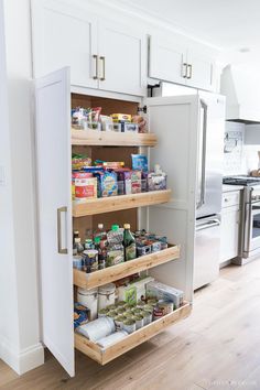 an organized pantry in the middle of a kitchen