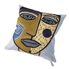 a pillow with a face painted on the front and side of it, sitting on a white surface