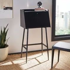 a chair and table in front of a window with a cityscape behind it