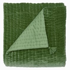 a green blanket with a triangle on it