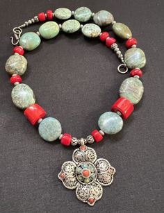 Lotus Filigree Nepalese Tibetan flower with turquoise and red Coral Necklace. | eBay Traditional Handmade Flower Necklace, Traditional Jewelry With Flower Charm And Shape, Traditional Jewelry With Flower Charm, Red Bohemian Flower Pendant Jewelry, Bohemian Red Flower Pendant Jewelry, Bohemian Flower Necklaces With Natural Stones, Bohemian Turquoise Flower Necklace, Unique Red Flower Jewelry, Unique Red Flower-shaped Jewelry