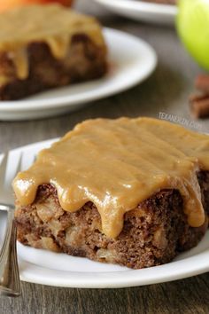 a piece of cake on a plate with caramel icing