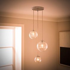 three lights hanging from a ceiling in a room