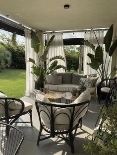 an outdoor living area with furniture and plants