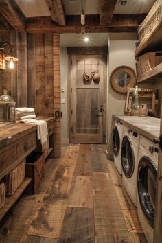 a washer and dryer in a room with wood flooring on the walls