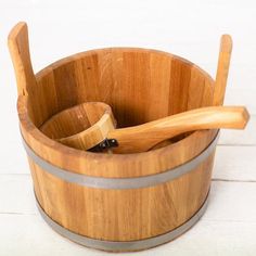 a wooden bowl with two spoons in it