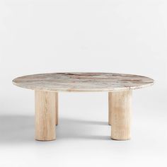 an oval marble table with wooden legs