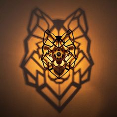 a lamp that is on the wall next to a light fixture with an intricate design