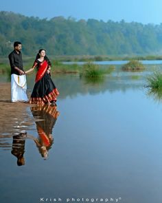 a man and woman are standing in the water