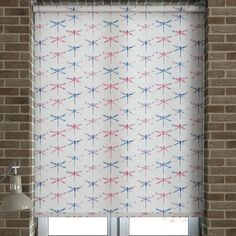 a window with a red, white and blue curtain in front of a brick wall