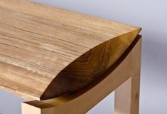 a close up of a wooden bench on a gray background