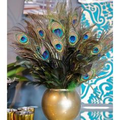 there is a vase with peacock feathers in it