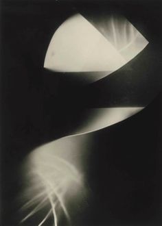 an abstract black and white photo with light coming from it