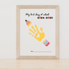 a framed poster with a pencil and handprints on it that says, my first day at school