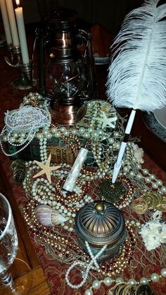 a table topped with lots of jewelry and candles