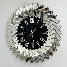 a clock made out of mirrors on the wall