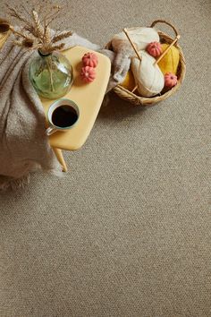 A side table with a cup of coffee, a blanket, a basket of wool and little pumpkins
on top of Cormar Carpets’ Malabar Two Fold carpet. Wool Twist, Neutral Carpet, Living Room Aesthetic, Timeless Decor, Neutral Decor, Room Aesthetic