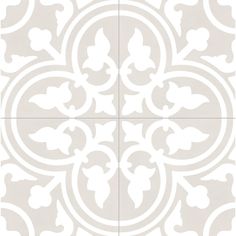 a white and gray tile pattern with an ornate design in the center, on top of it