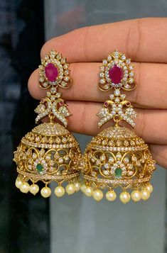 Gold CZ Diamond Jhumka Set, Pakistani Jewelry, Ruby Earring, Hanging Pearl Jhumki, American Diamond, Designer Jhumki Earring For Woman Color :    White / Golden   Gemstone :  Cubic Zircon / Gold Pearl / Stones Product Type :  Earring set,/ Jhumka Product Details : Our Jewelry is handcrafted by traditional artisans. Each piece is individually double checked for quality purposes.  Ideal Gift Idea: Perfect beautiful & memorable gift for you and your loving wife, girlfriend, sister, aunt, daughter and mom/mother/mummy. These are very skin Friendly. The plating is Non- Allergic and safe for all Environment. Made of long lasting brass metal, good quality. Hand finished. Raw Material - Artificial Jewelry, CZ Diamonds ,pearls Earrings Length =   3 Inch Occasion: Perfect choice for any Indian occas Round Jhumkas With Latkans For Reception, Reception Jhumkas With Latkans, Jhumka Set, Ruby Earring, Jewelry Ruby, Fancy Jewelry Necklace, Jhumki Earrings, Pearl Jewelry Sets, Pakistani Jewelry