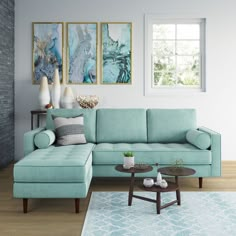 a living room with blue couches and pictures on the wall above them, along with a coffee table