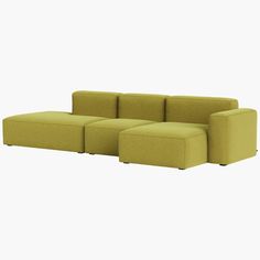 a large green couch sitting on top of a white floor