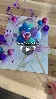 a person holding a lollipop in front of a new year's eve card