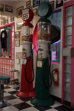 two gummy machines are in the corner of a room with checkered flooring