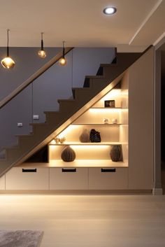 a room with some shelves and lights under the stairs