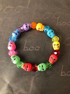 This is a Skull Beaded Bracelet. It would make a great gift for Halloween. It would make a great addition to your Halloween costume.  It has blue, pink, green, red, yellow, turquoise, and orange skull beads. It has 8mm faceted beads in purple, blue, pink, green, red, yellow, turquoise, and orange. It was made with .8mm sturdy stretch string. I tie it several times to prevent breakage. It fits girls ages 5-8. It stretches to fit on the wrist. All items are ready to be shipped I do combined shippi Halloween Multicolor Beaded Bracelets, Adjustable Multicolor Beaded Bracelets For Halloween, Halloween Novelty Multicolor Beaded Bracelets, Novelty Multicolor Beaded Bracelets For Halloween, Handmade Multicolor Bracelets For Halloween, Multicolor Beaded Halloween Jewelry, Multicolor Novelty Bracelets For Halloween, Fun Adjustable Jewelry For Halloween, Fun Multicolor Halloween Jewelry